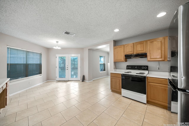 kitchen featuring a chandelier, a textured ceiling, light tile patterned flooring, white range with electric stovetop, and stainless steel fridge