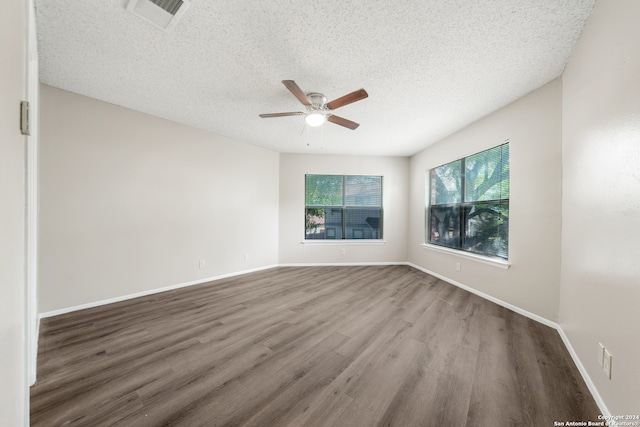 empty room featuring ceiling fan, a textured ceiling, and hardwood / wood-style floors