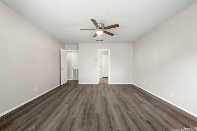 unfurnished bedroom with ceiling fan, a textured ceiling, and dark wood-type flooring