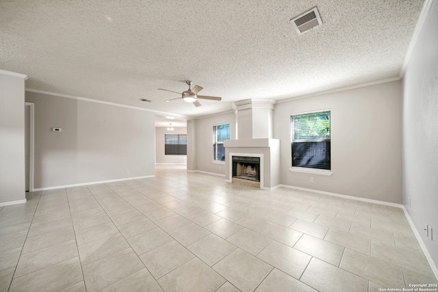 unfurnished living room featuring a textured ceiling, light tile patterned flooring, ornamental molding, and ceiling fan