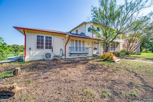 ranch-style home featuring ac unit and covered porch