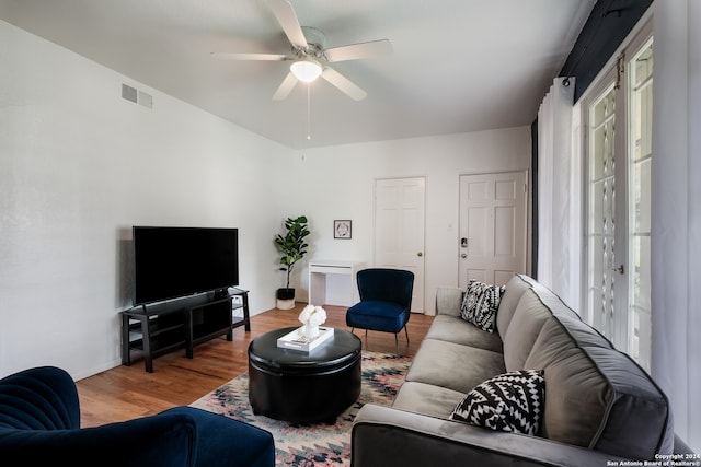 living room with hardwood / wood-style floors and ceiling fan