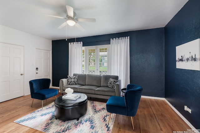 living room with ceiling fan and hardwood / wood-style floors