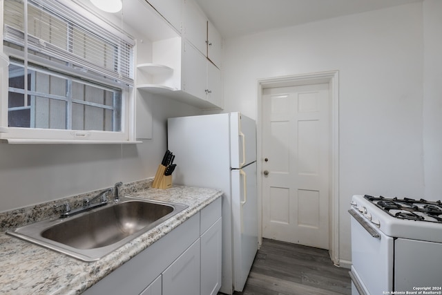 kitchen featuring white appliances, white cabinetry, sink, and dark hardwood / wood-style flooring