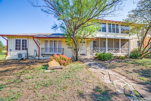 view of front of property featuring ac unit and covered porch