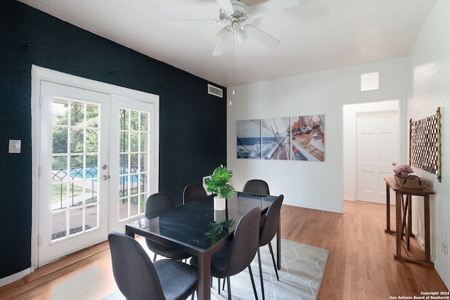 dining room with light wood-type flooring, ceiling fan, and french doors