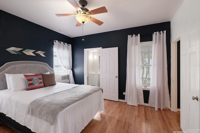 bedroom featuring wood-type flooring, ceiling fan, and connected bathroom