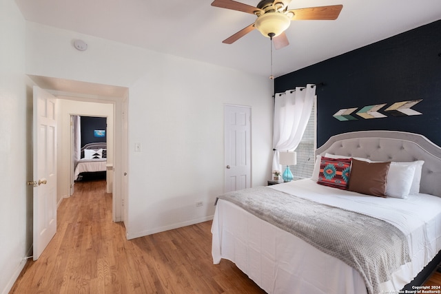 bedroom with ceiling fan and hardwood / wood-style flooring