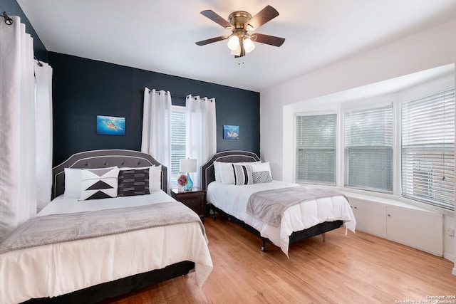 bedroom with light wood-type flooring and ceiling fan