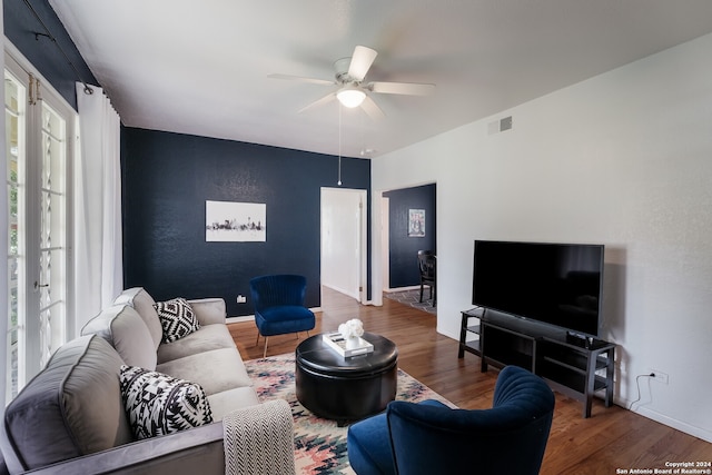 living room featuring ceiling fan and hardwood / wood-style floors