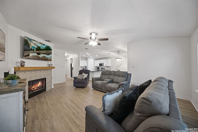 living room with ceiling fan and light hardwood / wood-style floors