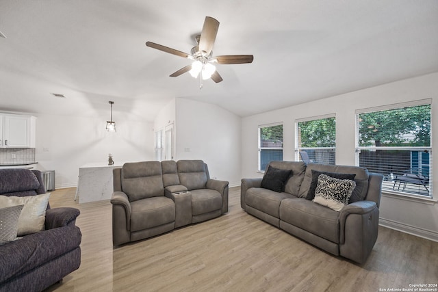 living room with ceiling fan, lofted ceiling, and light hardwood / wood-style floors