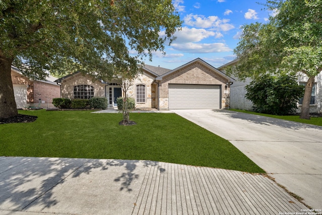 ranch-style house featuring a front yard and a garage