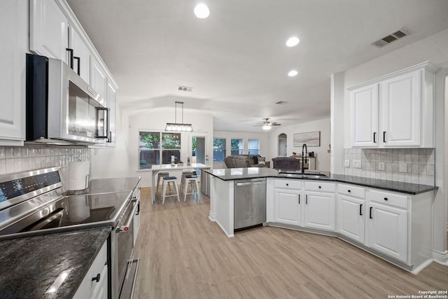 kitchen with appliances with stainless steel finishes, sink, ceiling fan, and white cabinets