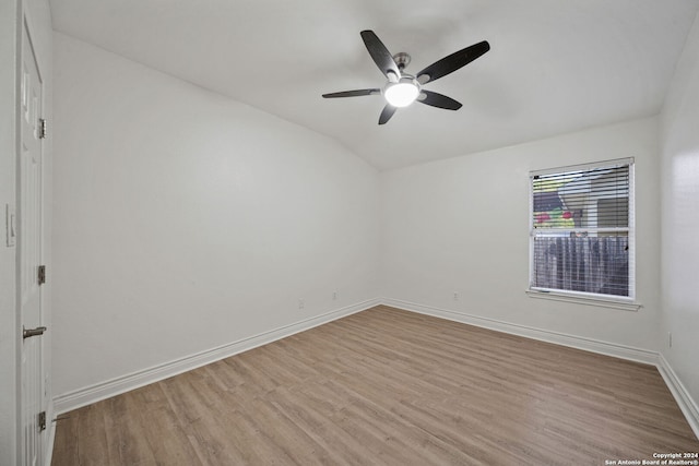 unfurnished room featuring lofted ceiling, light hardwood / wood-style floors, and ceiling fan