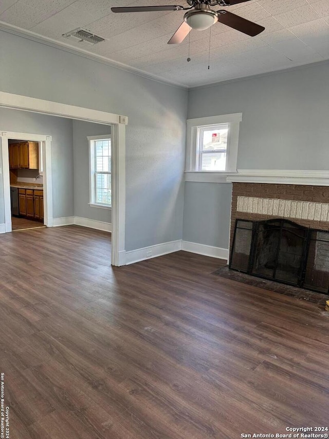 unfurnished living room with ceiling fan, a fireplace, and dark hardwood / wood-style floors