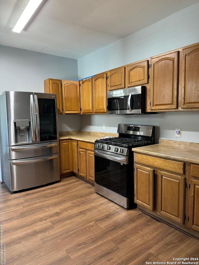 kitchen featuring wood-type flooring and appliances with stainless steel finishes