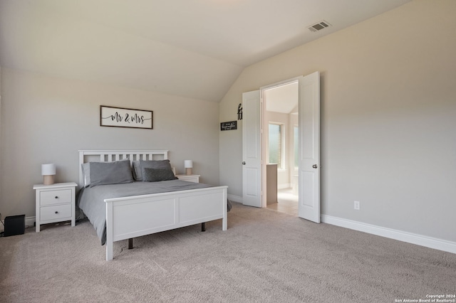 carpeted bedroom featuring lofted ceiling