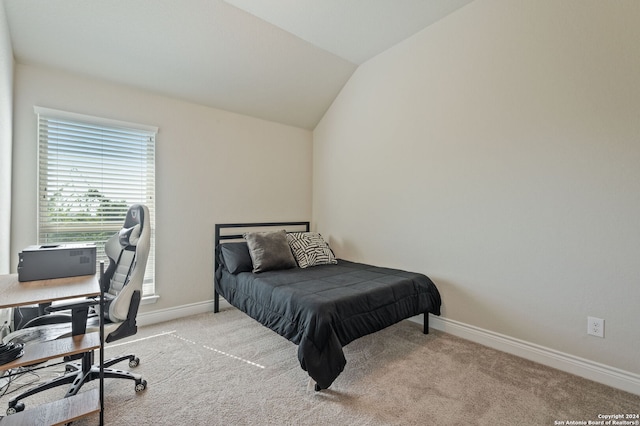 carpeted bedroom with lofted ceiling