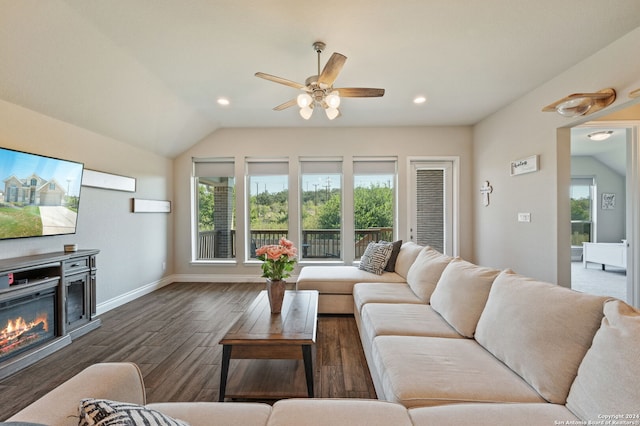 living room with lofted ceiling, a healthy amount of sunlight, and dark wood-type flooring