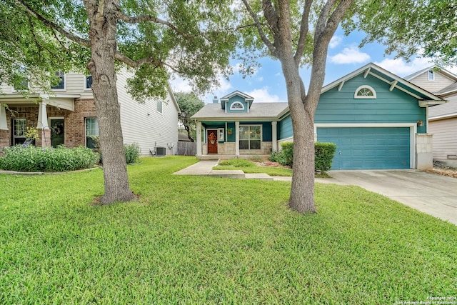 craftsman house with a garage, a front lawn, and central air condition unit