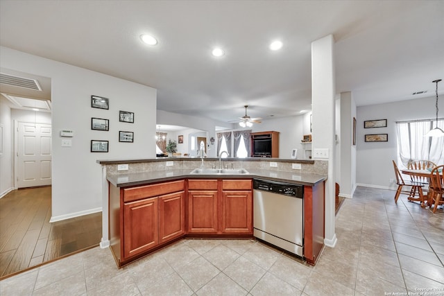 kitchen with ceiling fan with notable chandelier, pendant lighting, light hardwood / wood-style flooring, stainless steel dishwasher, and sink