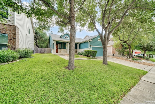 view of front of property with a garage and a front lawn