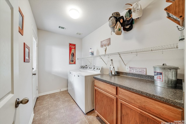 clothes washing area featuring light tile patterned floors and independent washer and dryer