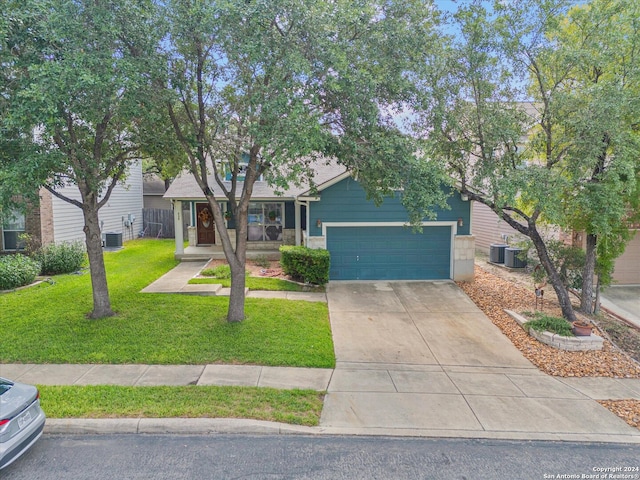 view of front of house featuring central AC unit, a front yard, and a garage