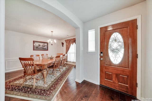 entrance foyer featuring a notable chandelier and dark wood-type flooring