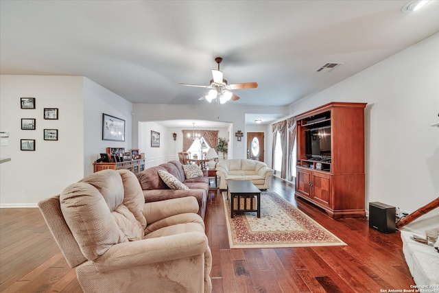 living room featuring ceiling fan and dark hardwood / wood-style floors