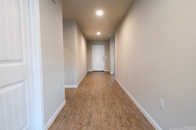 hall with light hardwood / wood-style floors