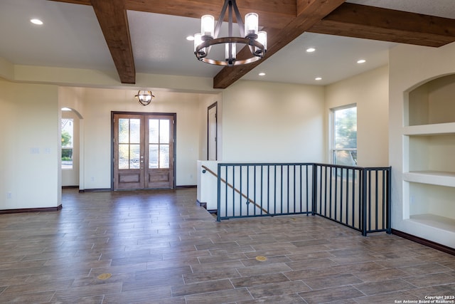 foyer featuring a notable chandelier, beam ceiling, and dark wood-type flooring