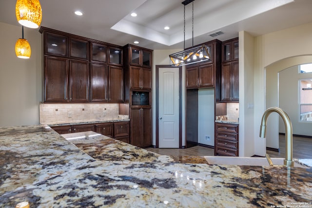 kitchen with sink, decorative light fixtures, and tasteful backsplash