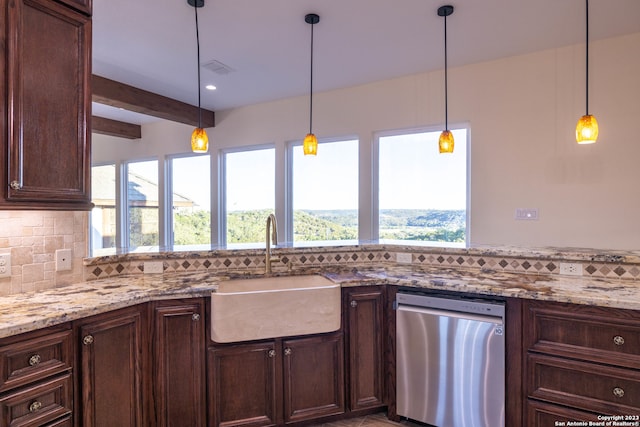 kitchen with decorative backsplash, light stone countertops, pendant lighting, stainless steel dishwasher, and sink