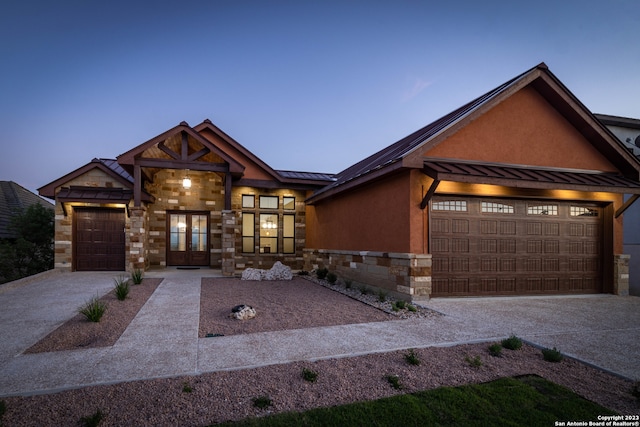 view of front facade with a garage and french doors