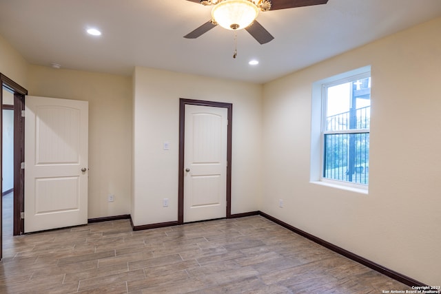 unfurnished bedroom with ceiling fan and light hardwood / wood-style floors