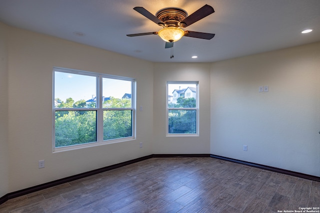 empty room with hardwood / wood-style floors and ceiling fan