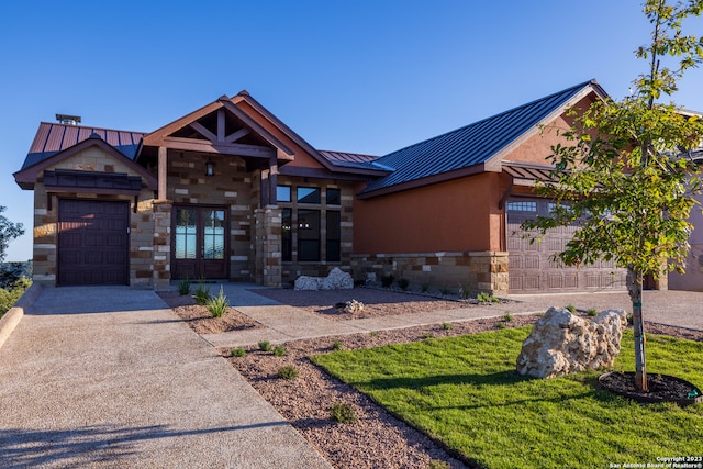 view of front of house with a garage and a front lawn