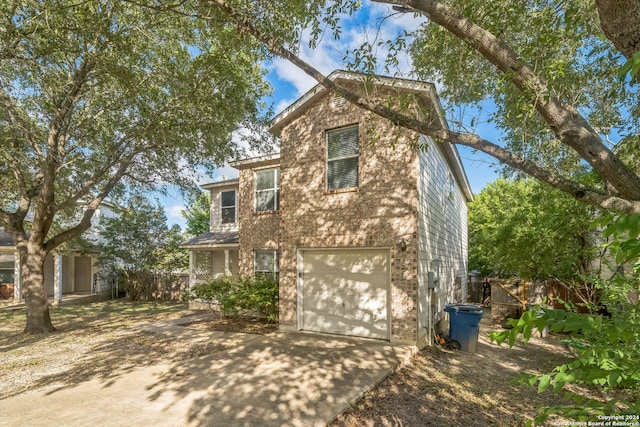 back of property featuring a garage