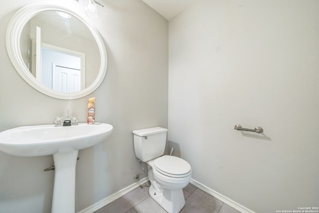 bathroom with tile patterned flooring and toilet