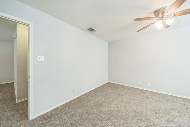 carpeted spare room featuring ceiling fan