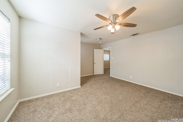 spare room featuring carpet floors and ceiling fan