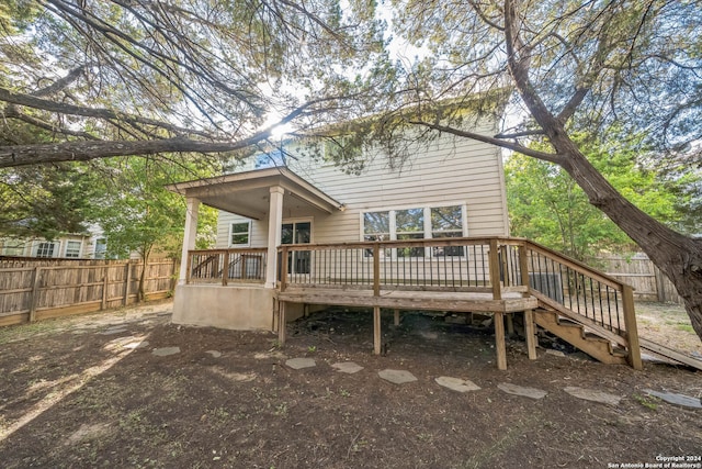 back of property with a wooden deck