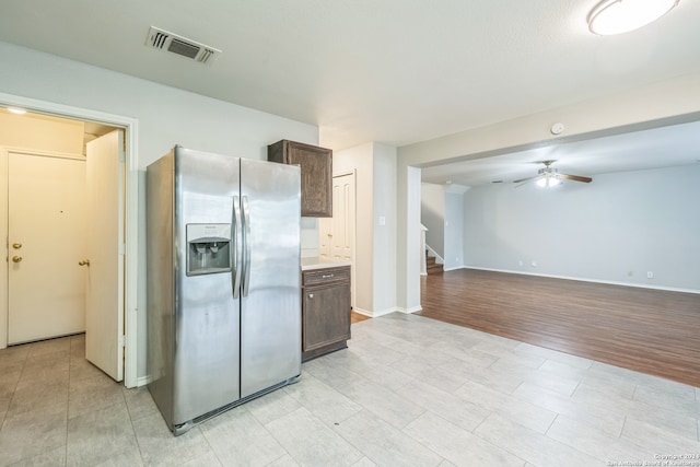 kitchen with light wood-type flooring, stainless steel fridge, dark brown cabinetry, and ceiling fan