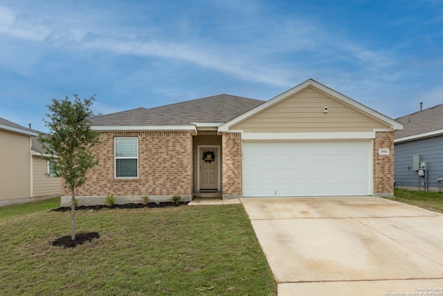 ranch-style house featuring a garage and a front yard