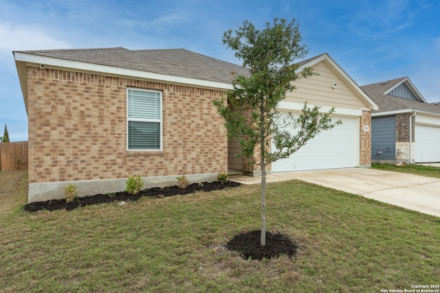 ranch-style home featuring a garage and a front lawn