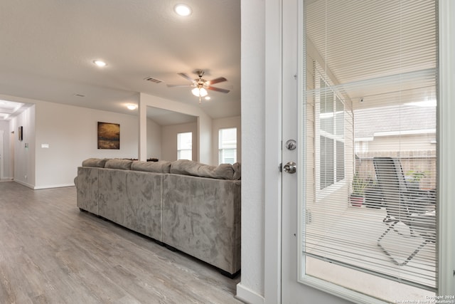 living room featuring ceiling fan and hardwood / wood-style flooring