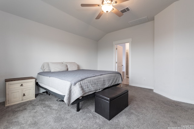 bedroom with ceiling fan, light colored carpet, and vaulted ceiling