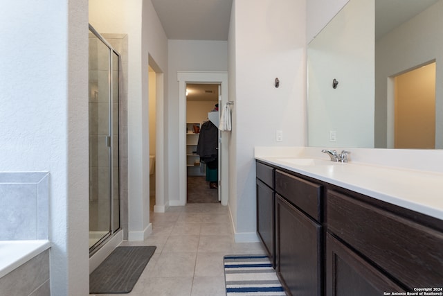 bathroom with tile patterned flooring, vanity, and an enclosed shower